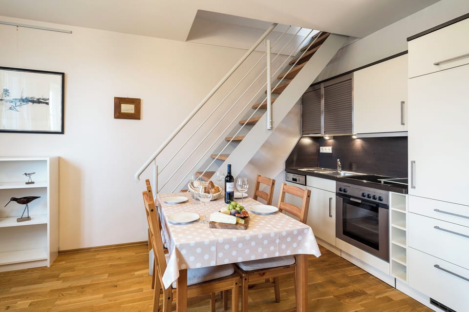 Modern Kitchen with Dining Table and Stairs