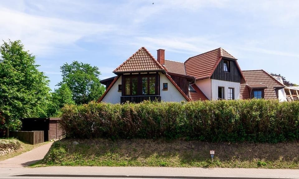 Exterior view of a house with a red roof