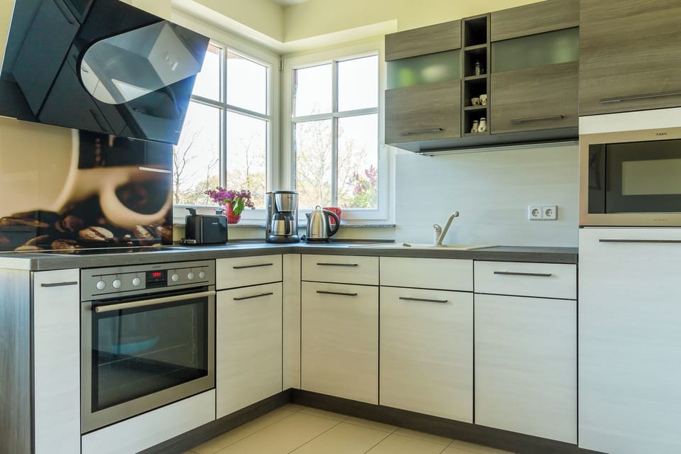 Modern kitchen with stove and windows