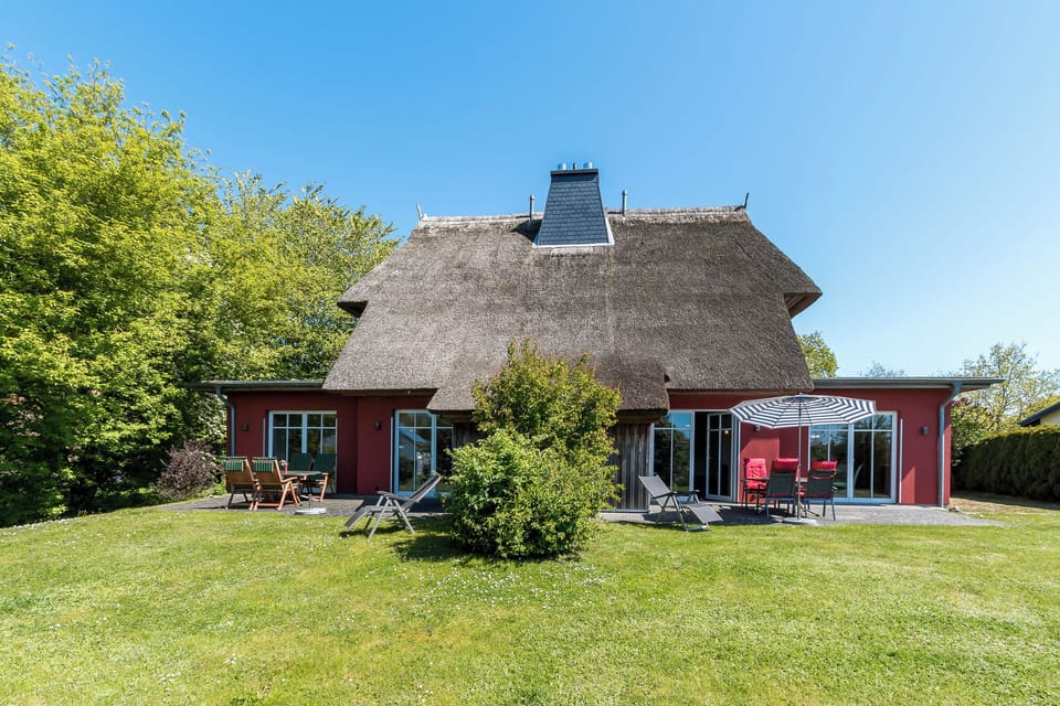 Exterior View of a Thatched House with Garden