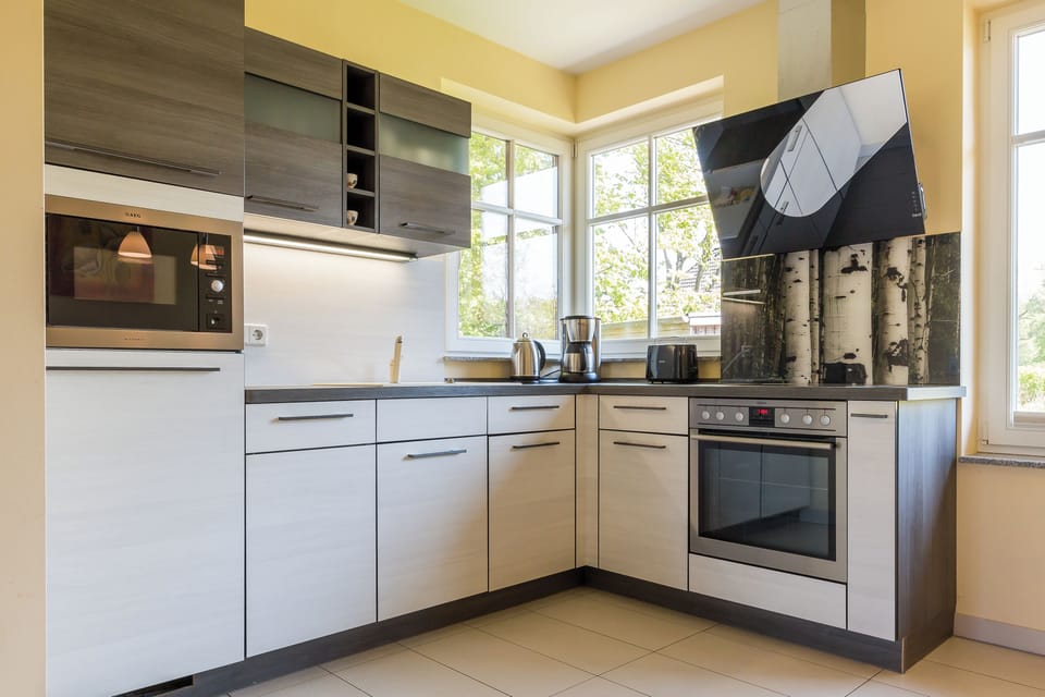 Modern kitchen with appliances and large windows