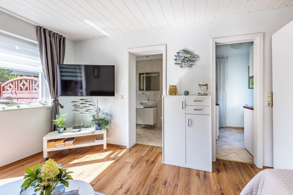 Bright Living Room with TV and Plants