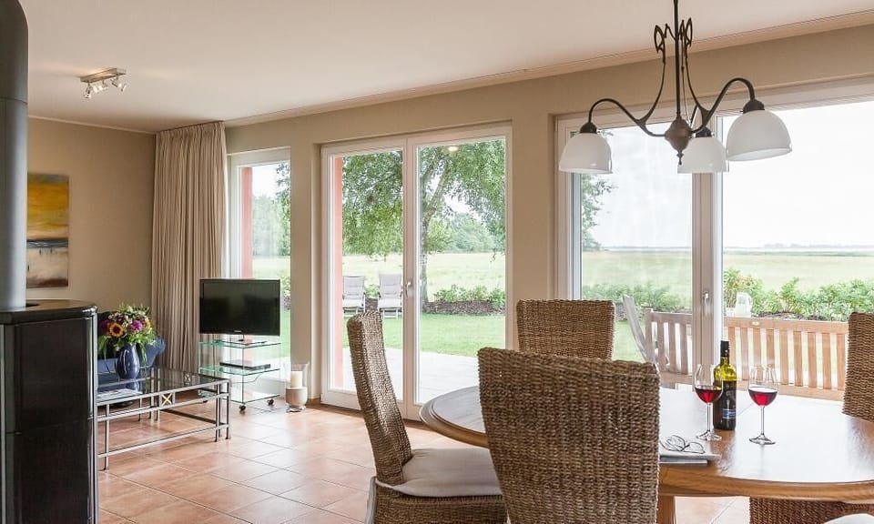 Living Room with Dining Table and Garden View
