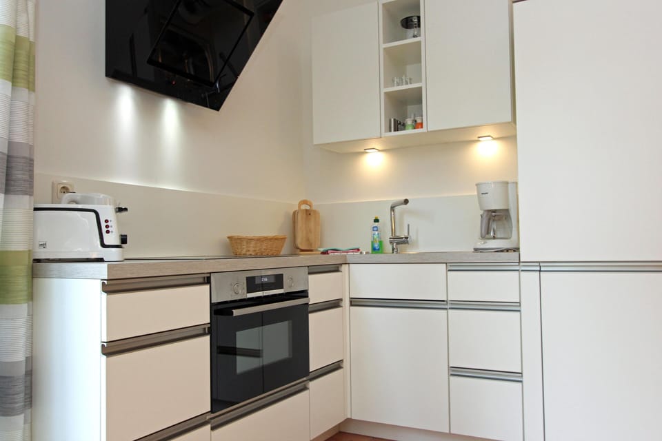 Modern Kitchen with White Cabinets and Cooking Area