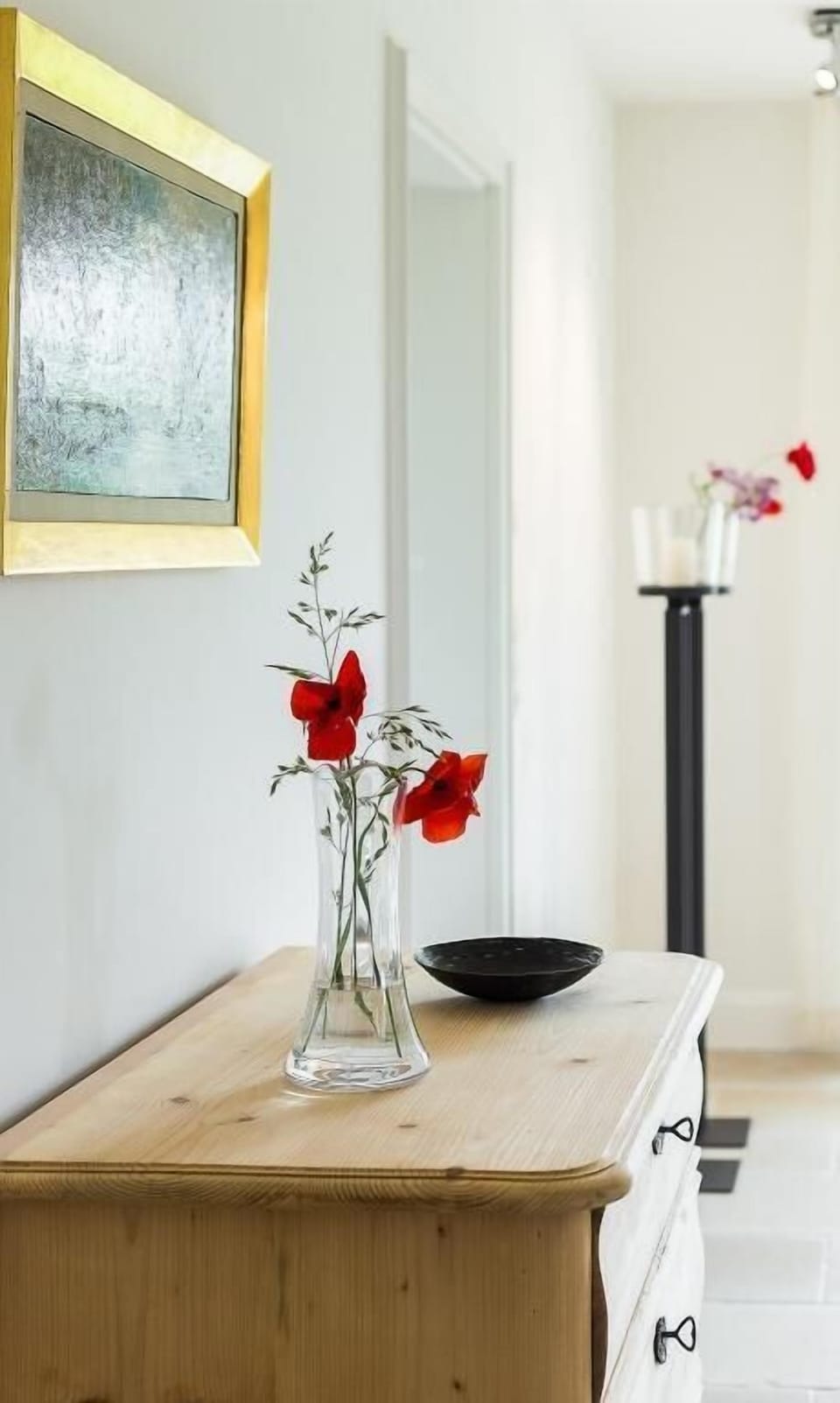 Interior view with wooden dresser and flowers