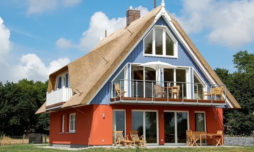 Facade of a Modern Holiday House with Thatched Roof