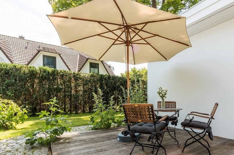 Terrace with umbrella and garden furniture