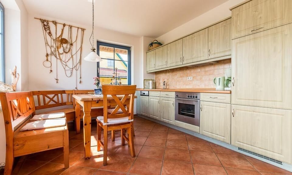 Bright kitchen with wooden cabinets and dining table