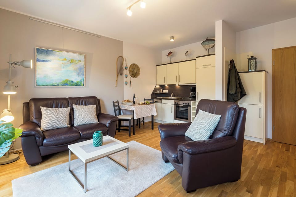 Cozy Living Room with Leather Sofas and Kitchen