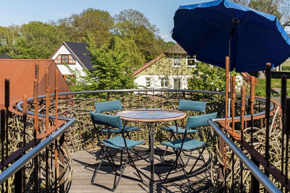 Terrace with table and chairs under sunshade