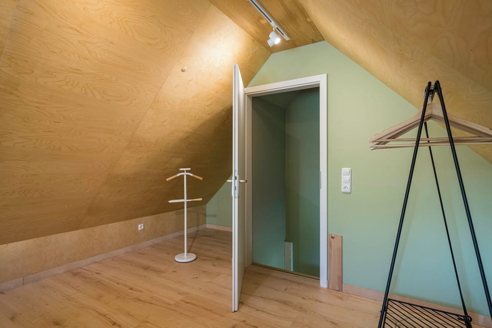Bedroom with sloped walls and minimalist decor