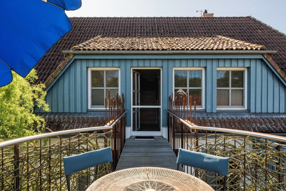 Terrace with Table and Blue Chairs