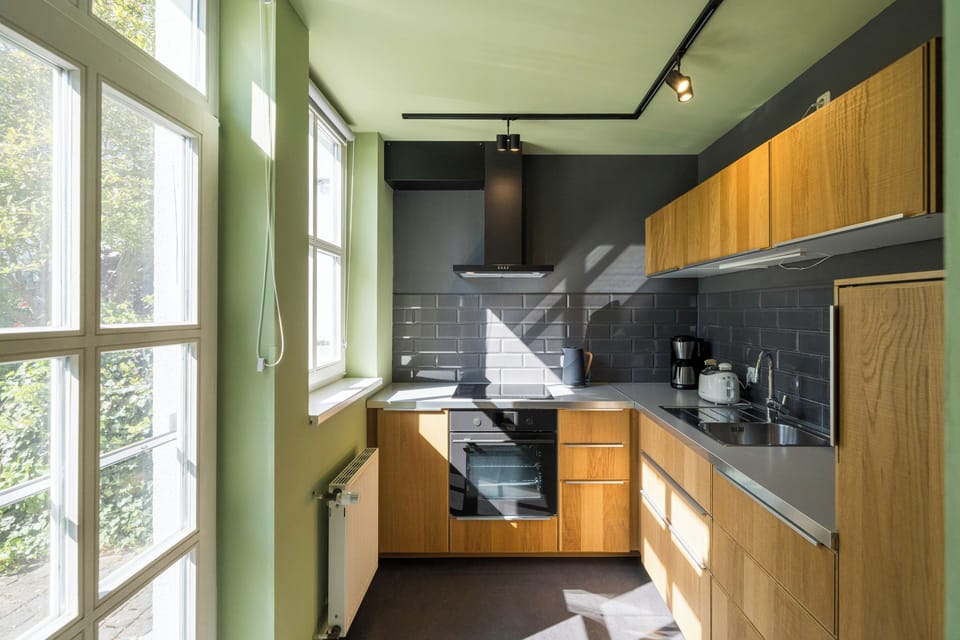 Modern Kitchen with Wooden Cabinets and Large Windows