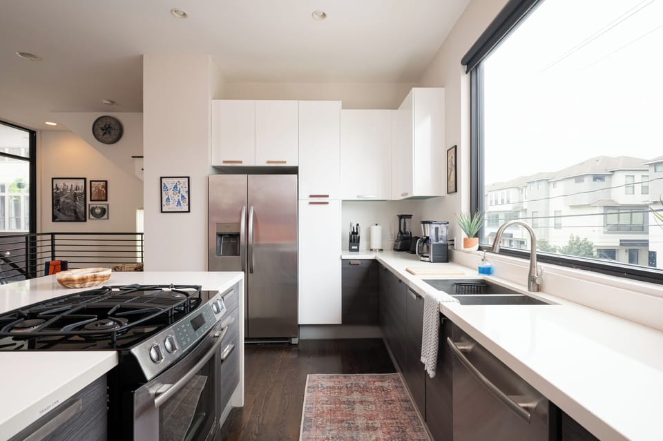 This bright and airy chef’s kitchen is designed for both convenience and style! Featuring stainless steel appliances, a gas stove, and a fully stocked coffee bar, it’s the perfect space to whip up a delicious meal or enjoy a morning brew with a view.