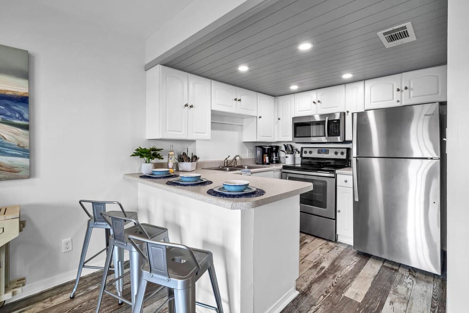 Your fully equipped kitchen features stainless steel appliances, granite counters, and a breakfast bar where you can enjoy morning coffee together.