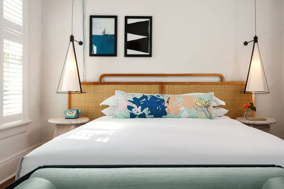 Stretch out on a perfectly made bed framed by warm art.