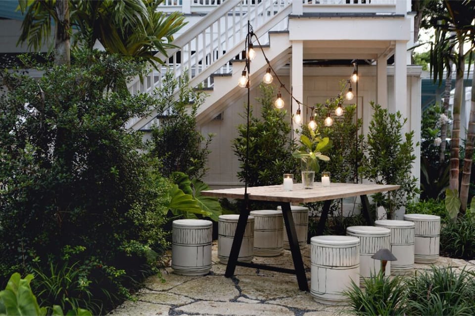 Gather under glowing string lights for effortless alfresco dinners.