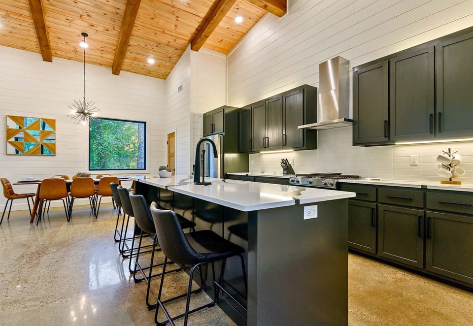 A spacious open-concept kitchen with soaring ceilings and rustic-chic lighting that makes cooking feel like a treat.