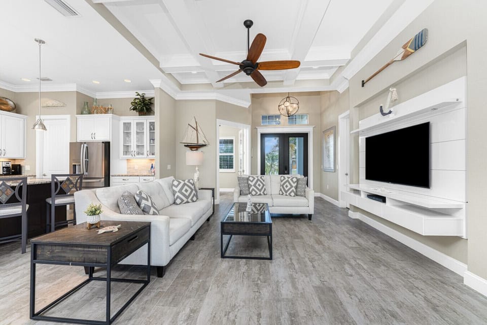 Open-concept living area with Smart TV and comfy chairs in this waterfront vacation home