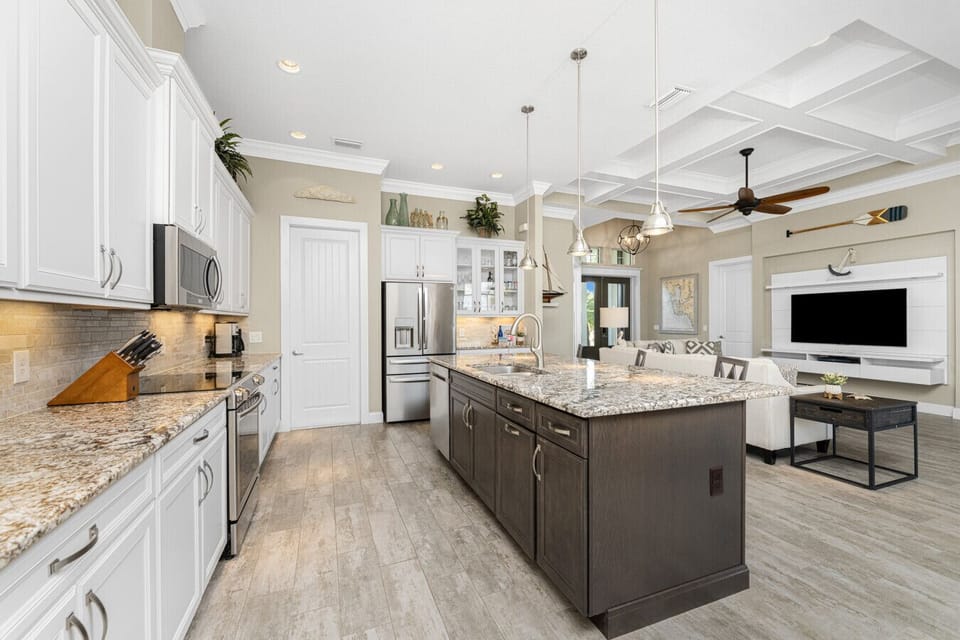 Spacious and tastefully designed kitchen at Aqua Circle Tides House featuring modern appliances and island seating in Englewood, FL