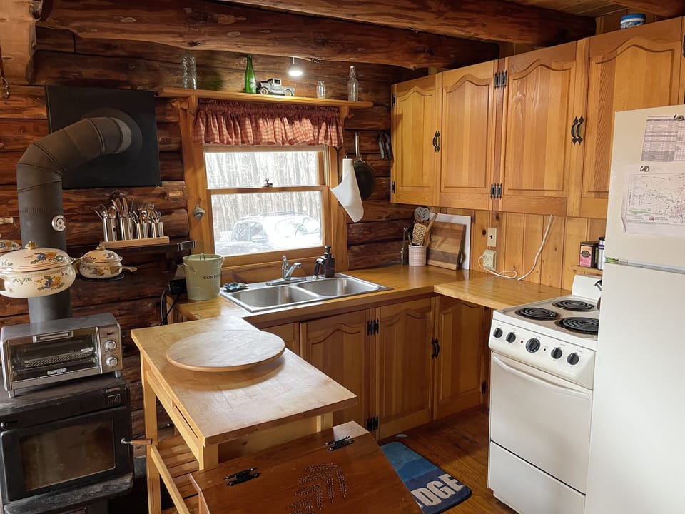 Full kitchen with refrigerator, stove, and oven.
