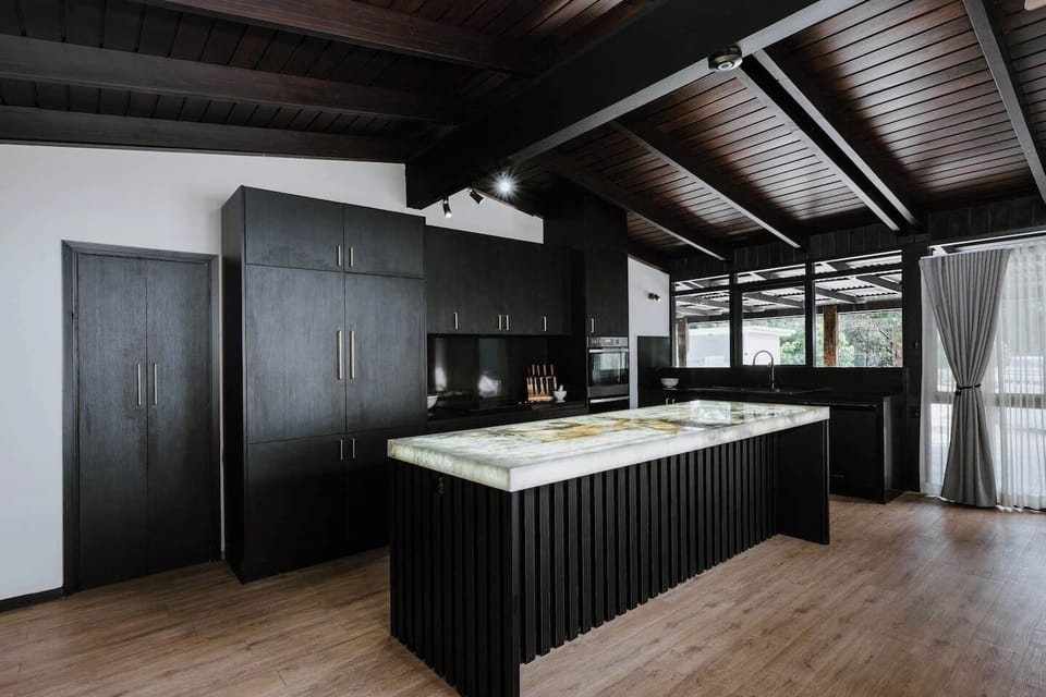 Channel your inner chef in an opulent kitchen designed for effortless entertaining, complete with a stone island, premium appliances, and a walk-in pantry stocked with thoughtful touches.