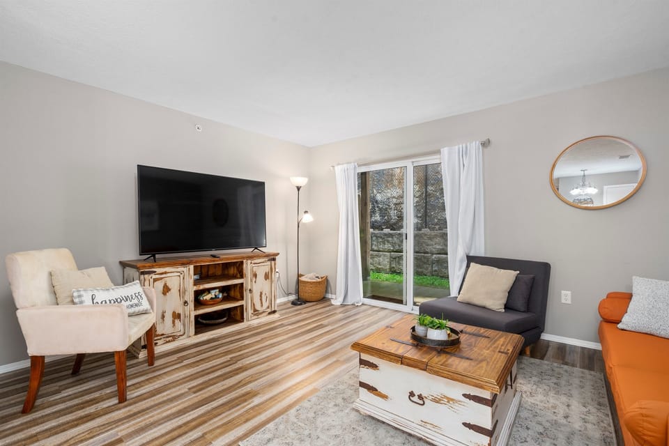 Spacious living room with comfy seating and a large TV for entertainment. Both the sofa bed and the chair convert for additional sleeping