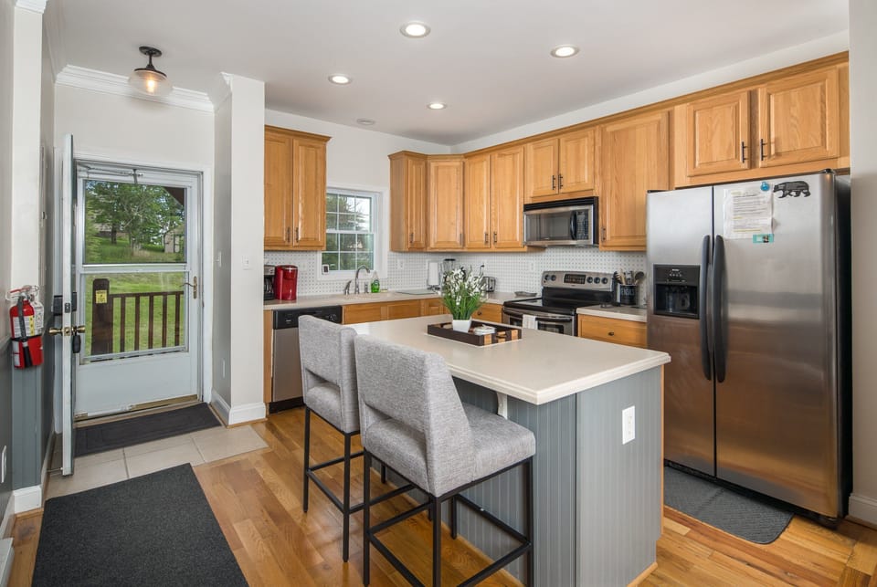 Light-filled kitchen with modern appliances and warm finishes.