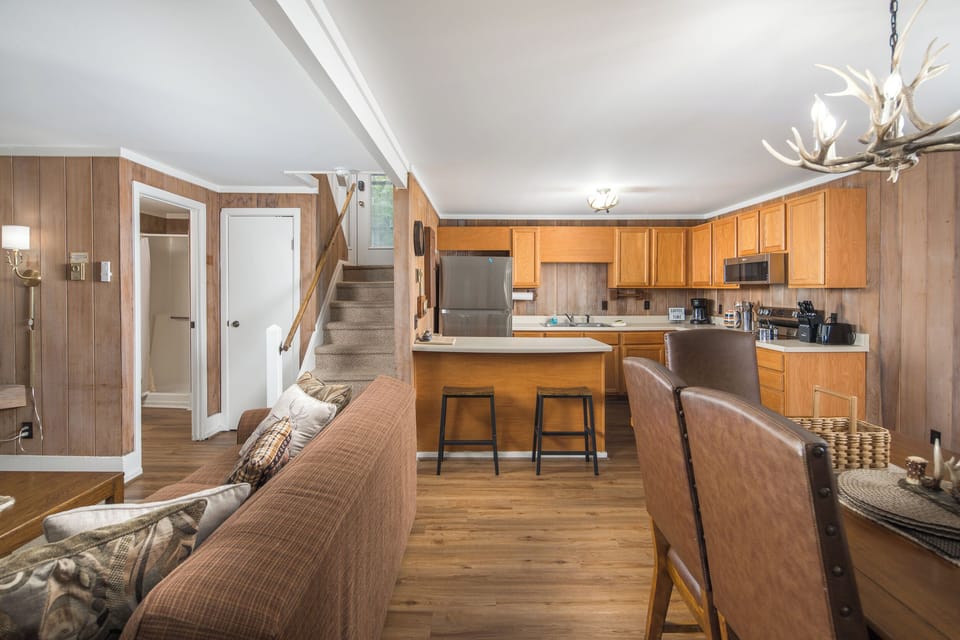 Open kitchen and dining area with breakfast bar seating.