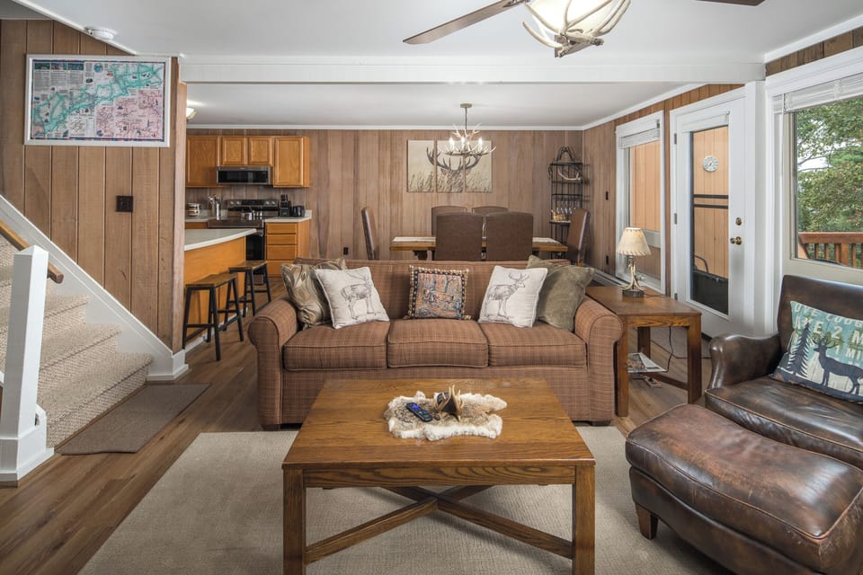 Open living area with seating, dining space, and kitchen access.