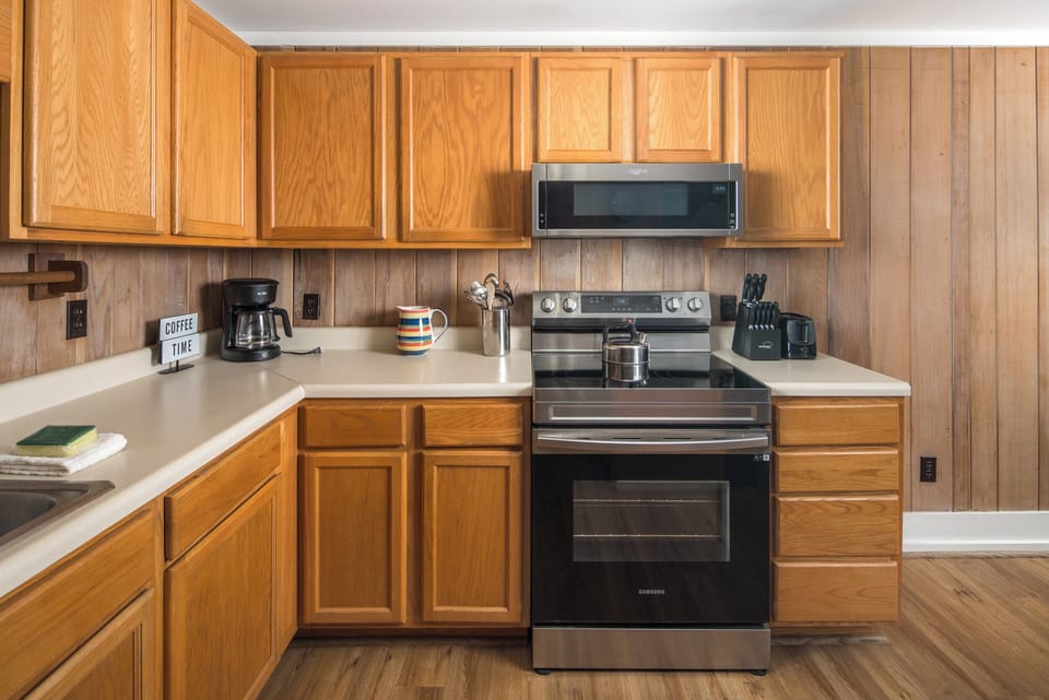 Fully equipped kitchen with stainless steel appliances and ample counter space.