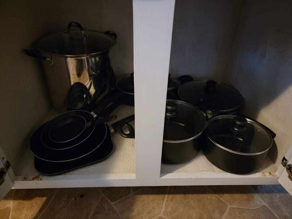 Pots and pans in cupboard.  The big pan works great for corn on the cob.