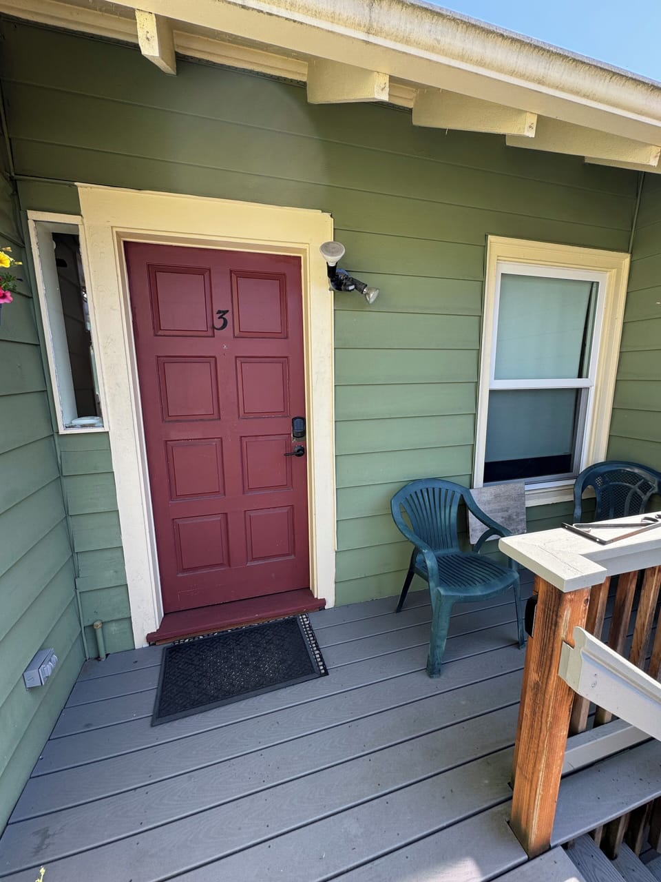 Door to the unit with small balcony at the top of the stairs.