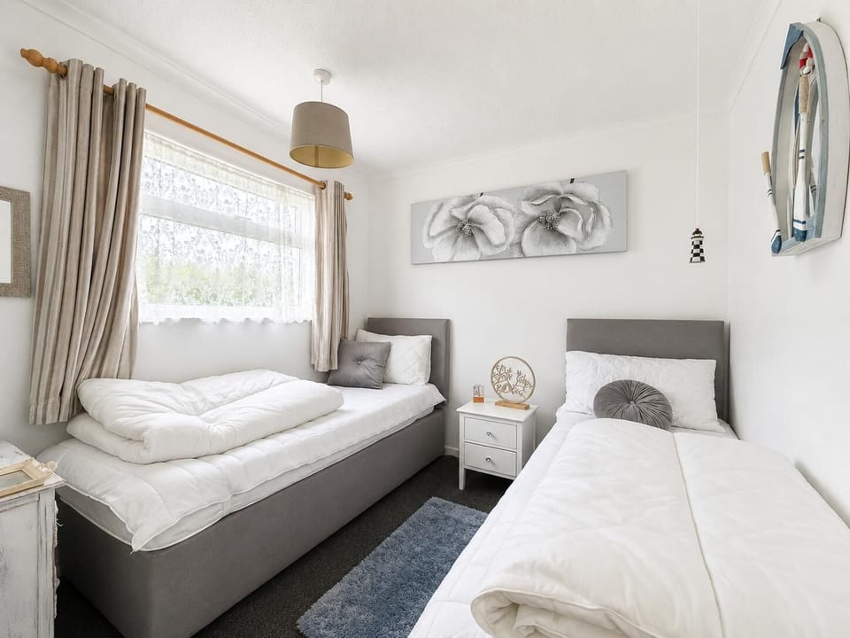 Comfortable twin bedroom with two single beds.