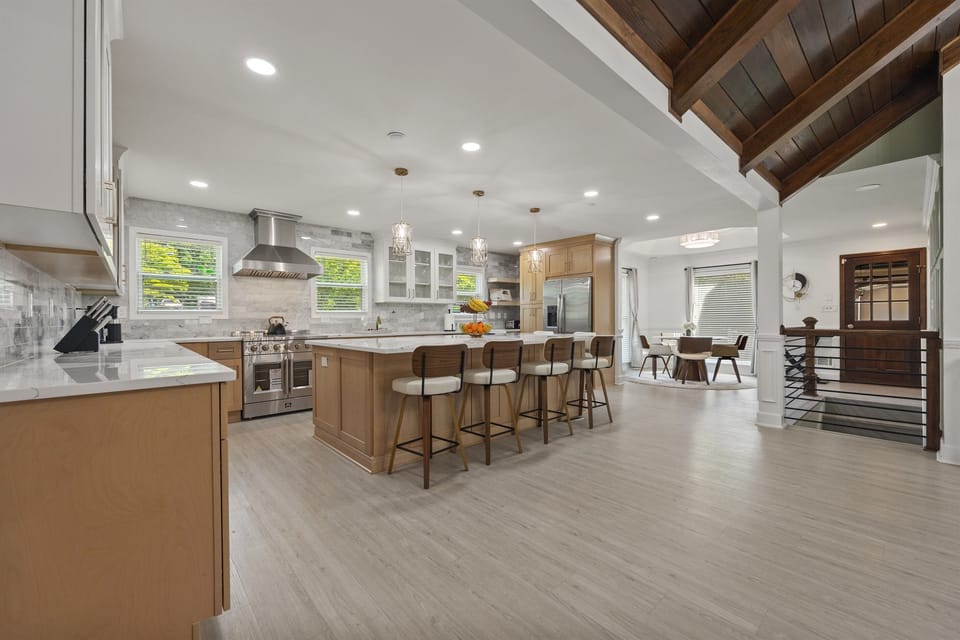 Open-concept kitchen and dining area with high-end appliances, spacious island seating, and natural light—perfect for family meals and entertaining.