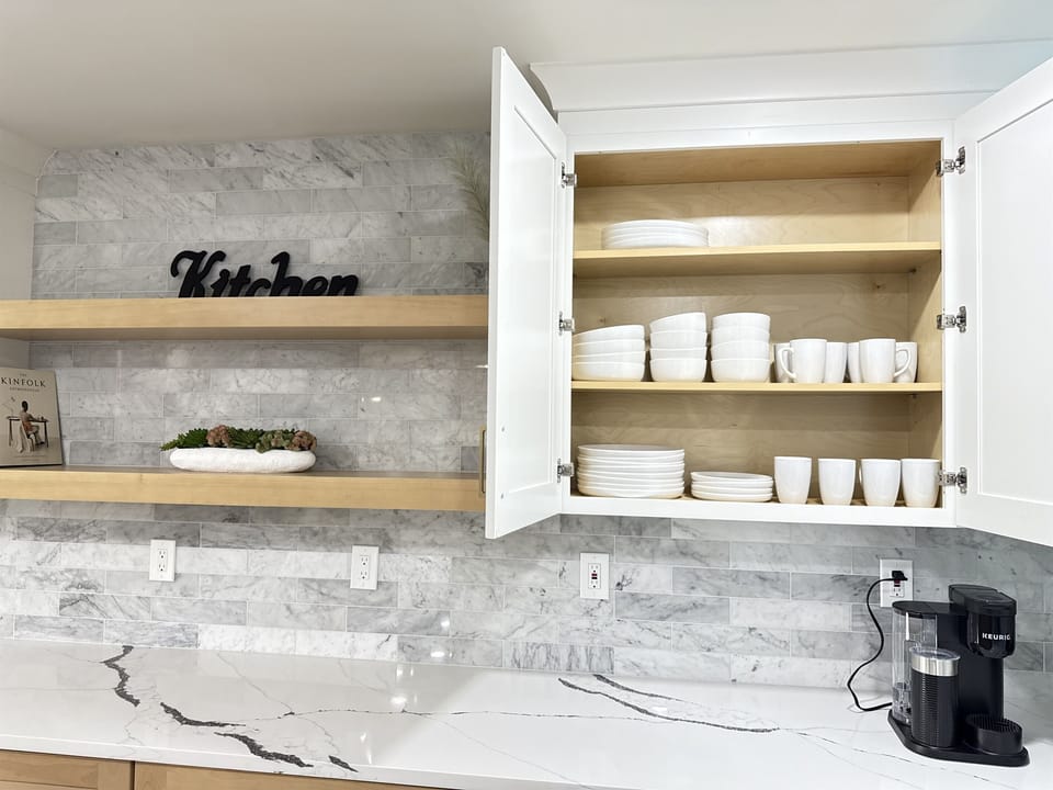 Pour up your favorite vintage or mocktail using the elegant glassware displayed behind glass-front cabinets.