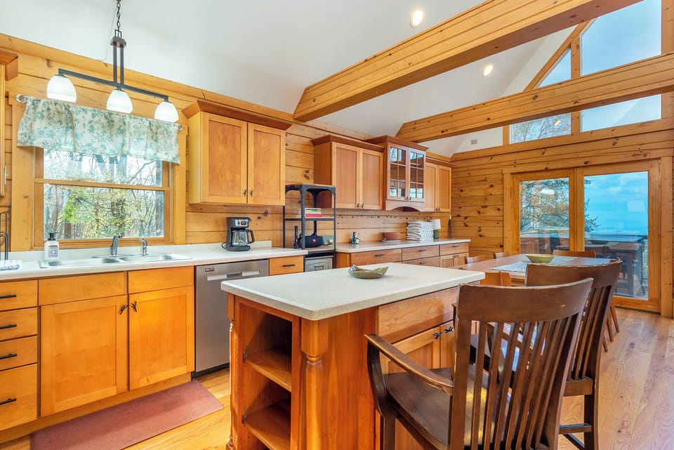 Kitchen with drip-style coffee maker, dishwasher, and breakfast bar seating for 2
