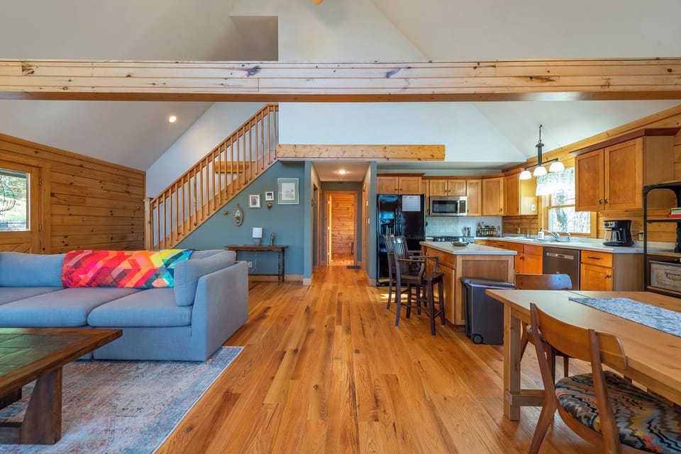 Open-concept main floor with cozy living area, dining, and kitchen