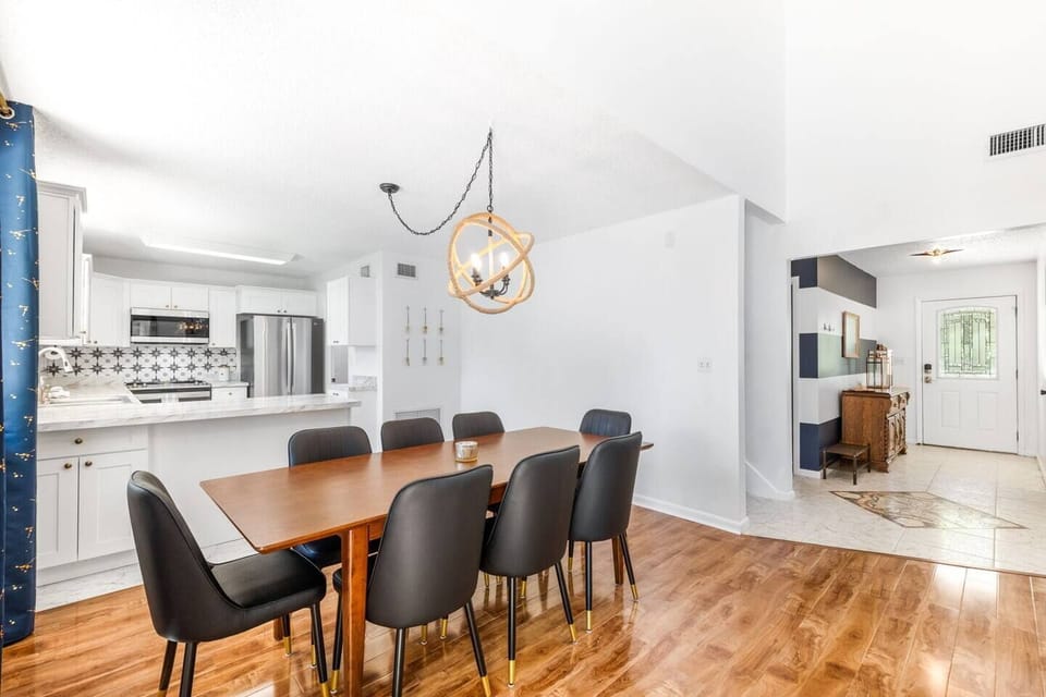 Spacious dining area with stylish seating for eight, perfect for gathering around delicious meals and engaging conversations.