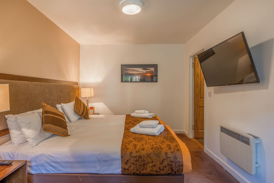 Settle into a calm room with wall-mounted TV convenience.