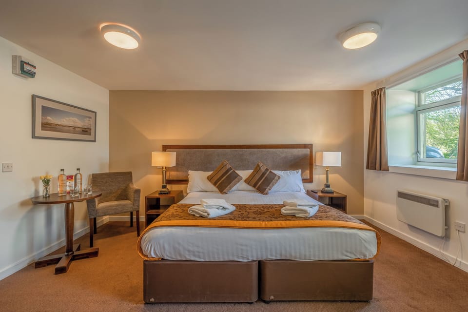 Unwind into crisp linens with warm lamps and garden views.