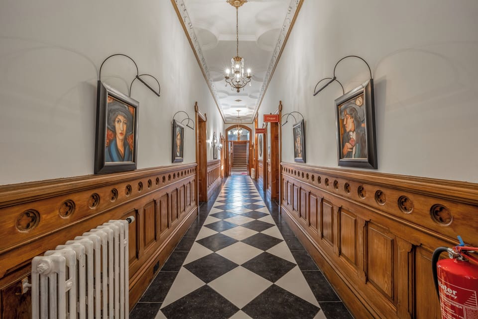 Wander a timeless hallway with striking black-and-white floors.