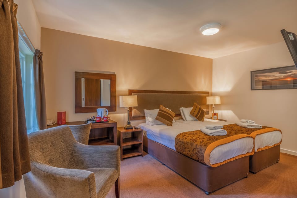 Lounge after check-in in a spacious room with warm tones.