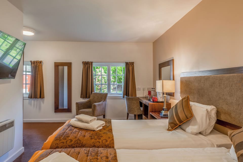 Drift off comfortably with soft lighting and neatly layered linens.