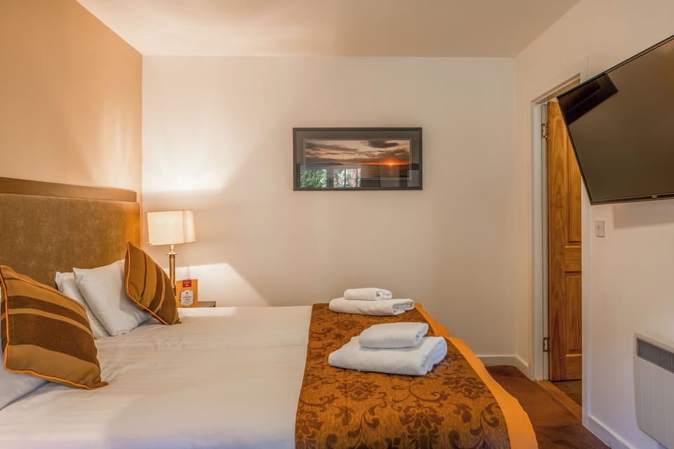 Relax into crisp bedding and enjoy a movie from bed.