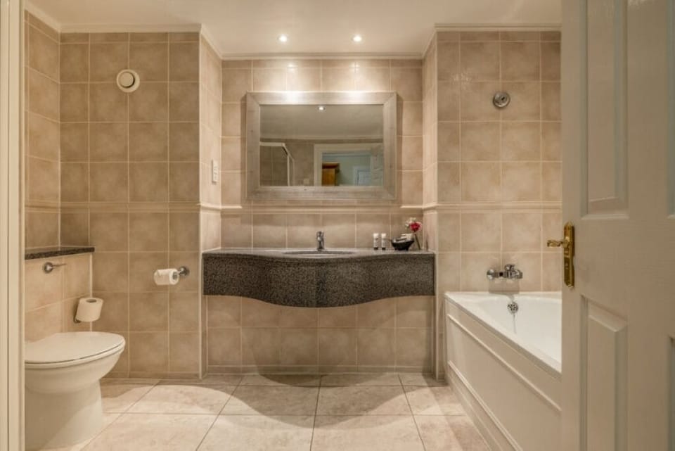 Refresh in a spotless bathroom with generous vanity space.