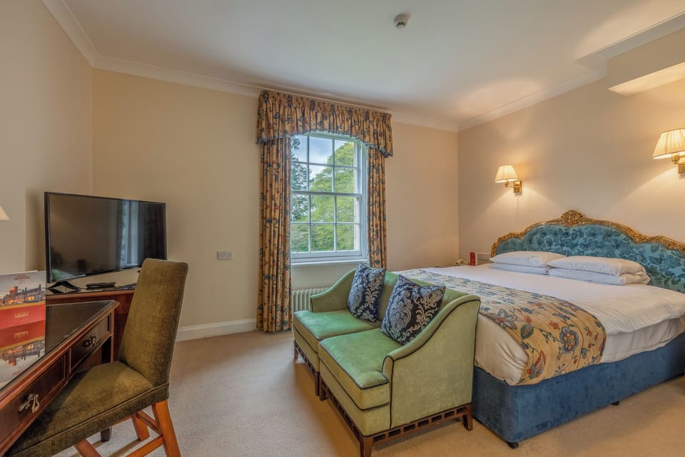 Unwind on the plush settee beside sunlit garden views.