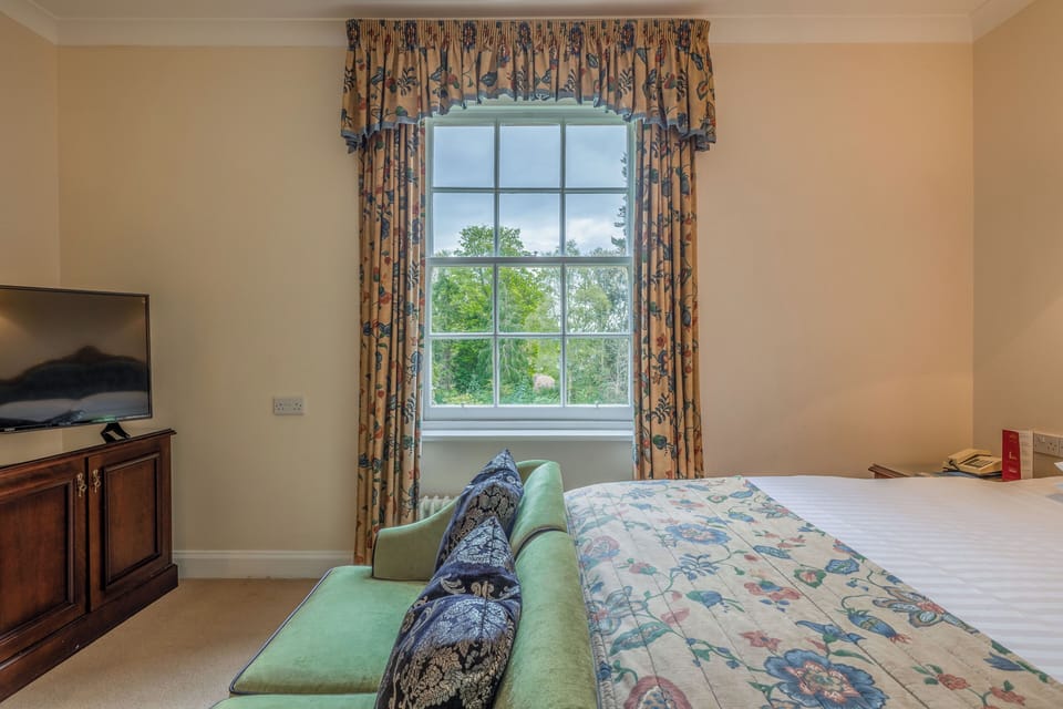 Sip morning coffee by the window overlooking leafy greenery.