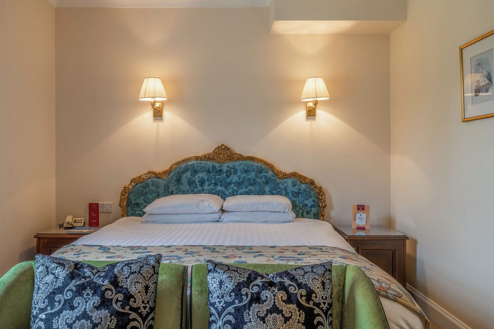 Sink into plush pillows beneath a beautifully upholstered headboard.