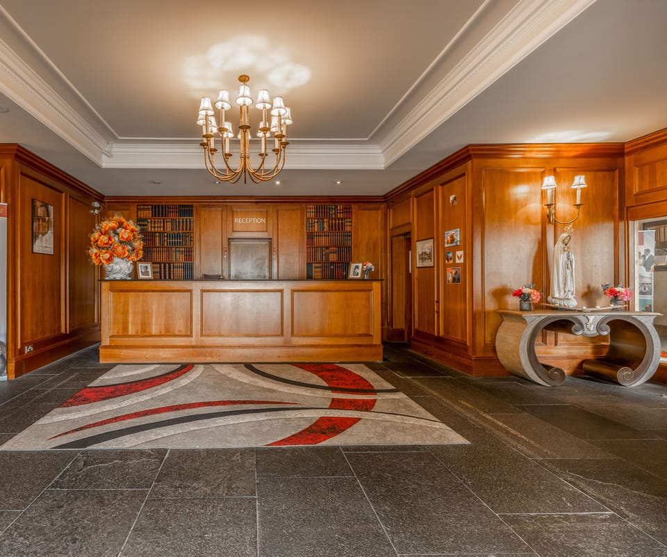 Arrive and unwind in a grand lobby with chandeliers.